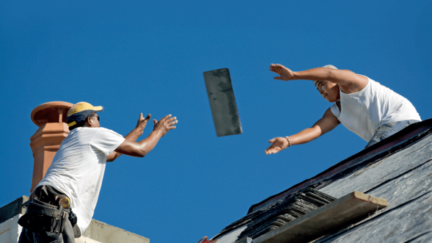 Builders passing roof tile