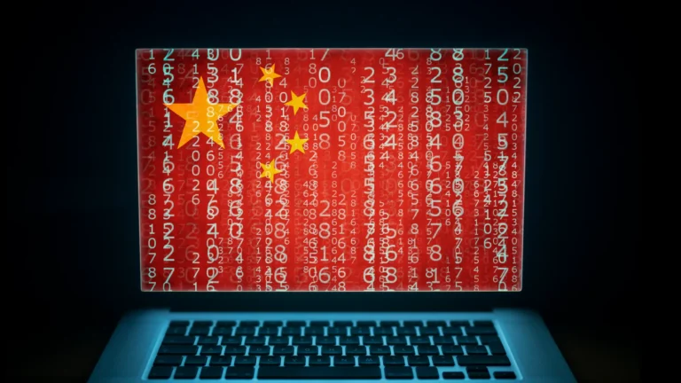 A laptop with a large Chinese flag on the screen, covered in a series of number codes