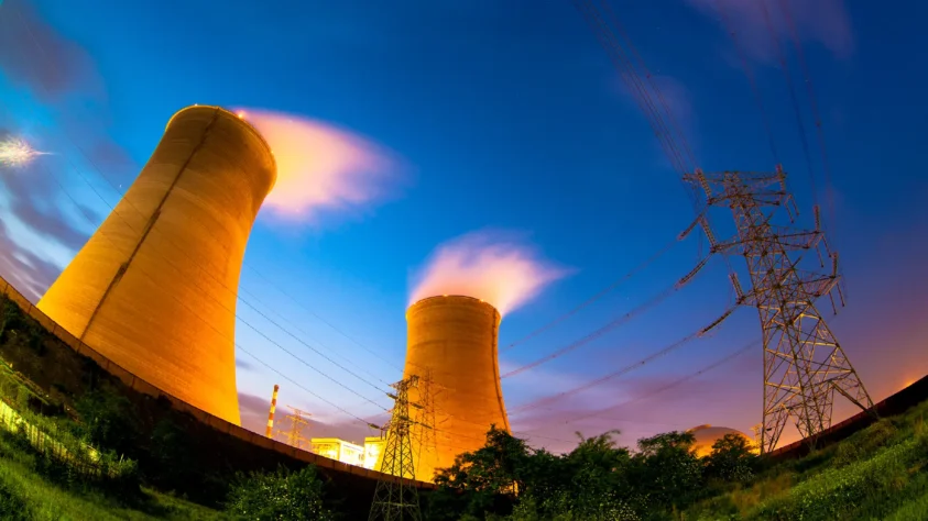 Fishbowl lense view of a nuclear power plant at sunset