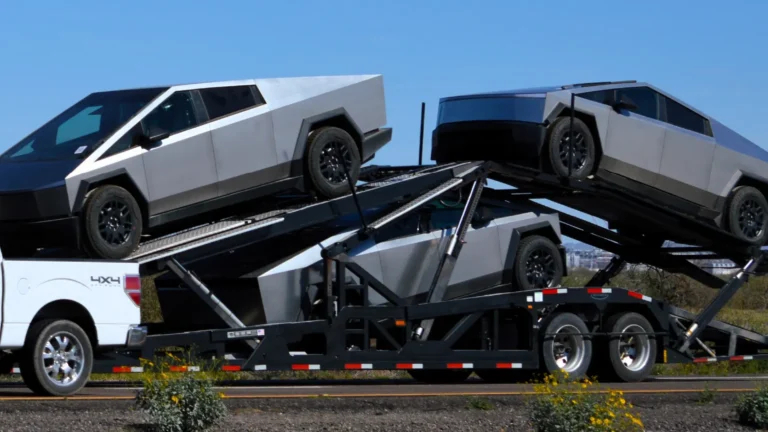 Theree Tesla Cybertrucks being pulled on a car hauler
