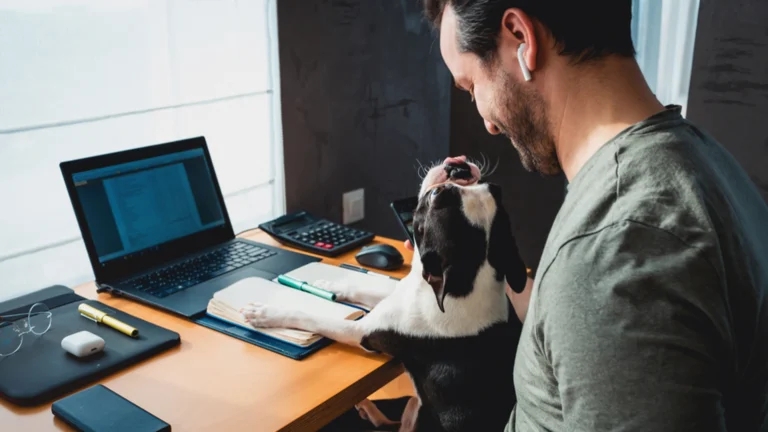 man working from home with a dog